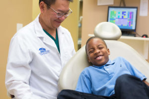 Little boy laughing at dentist