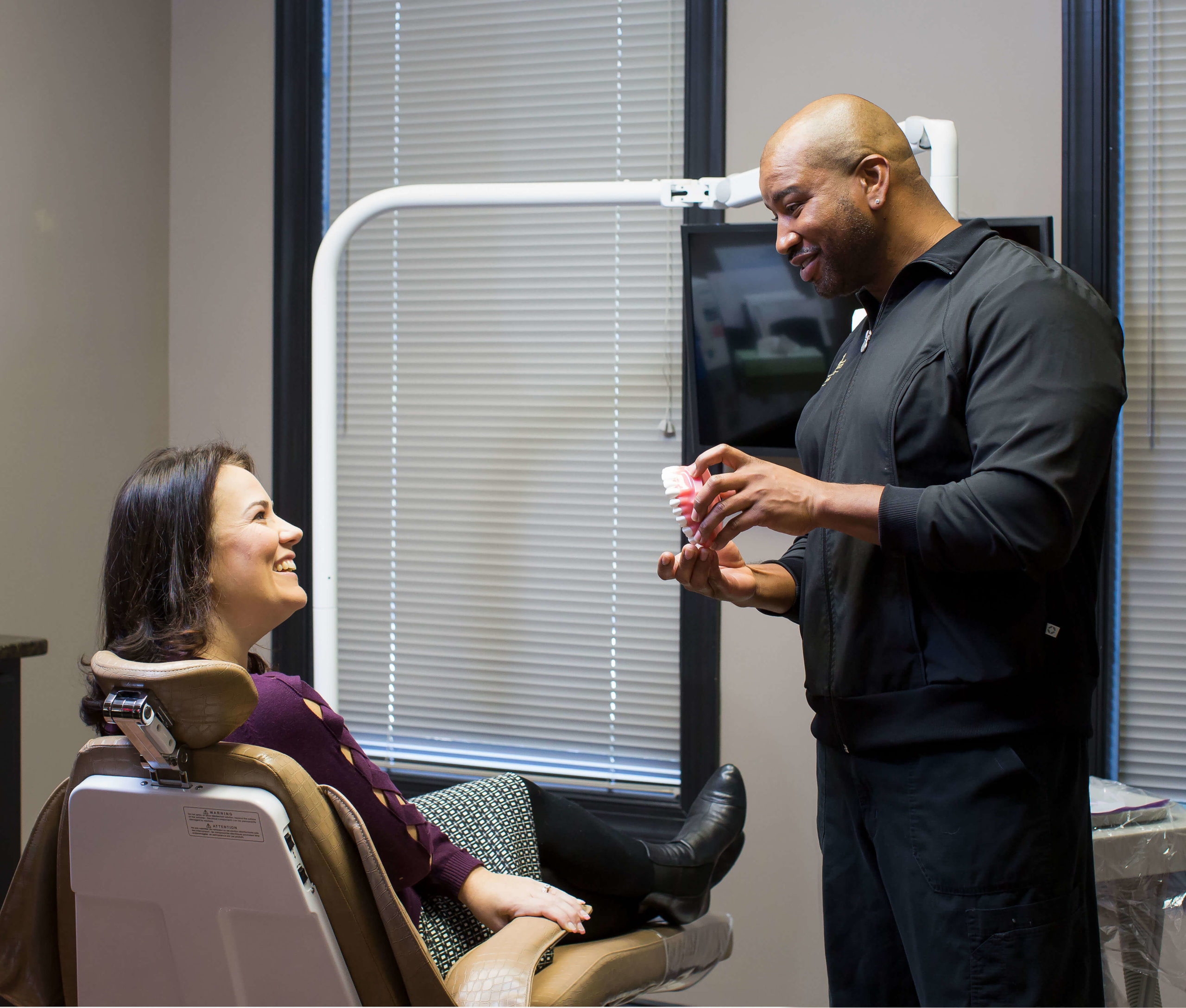 dental hygienist explains to patient