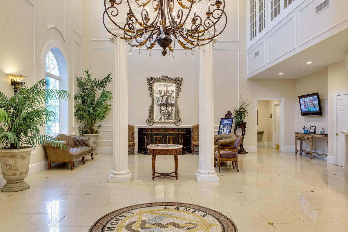 Huge Garner dentist office lobby with grand chandelier and white cream columns