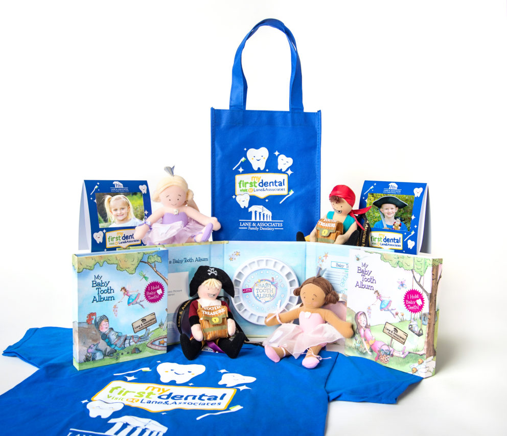 Cobalt blue bag with My First Dental Visit logo, two tooth fairy dolls, two pirate dolls, a kids sized t-shirt, and baby tooth album