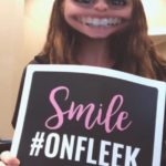 Lane and Associates Family Dentistry employee holding up My Social Practice sign that says "Smile #OnFleek"