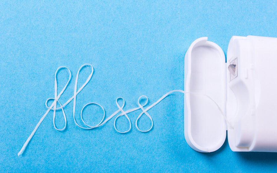 Floss string spelling out "Floss" with blue surface