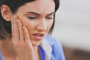 tooth pain woman holding her jaw