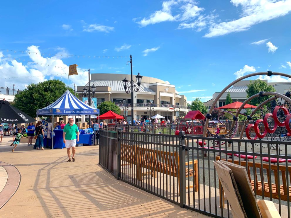 Blue and White striped tent that says Lane and Associates Family Dentistry at Concert Series