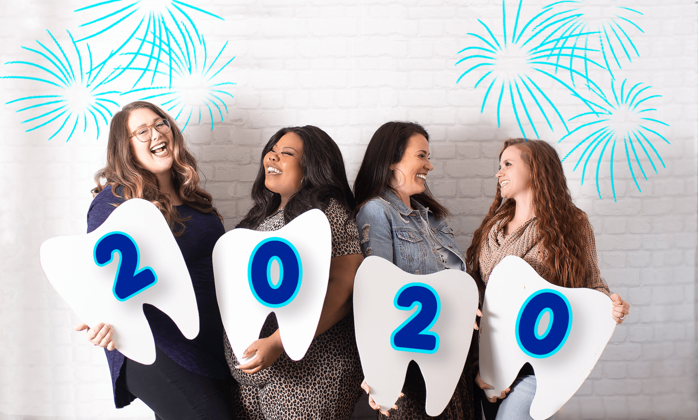 Marketing team smiling with 2020 Tooth signs