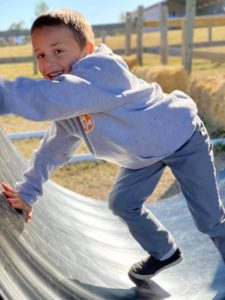 Boy climbing on tube