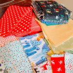 stacks of blue yellow and red fabric