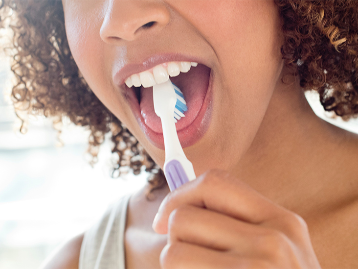 person brushing their tongue
