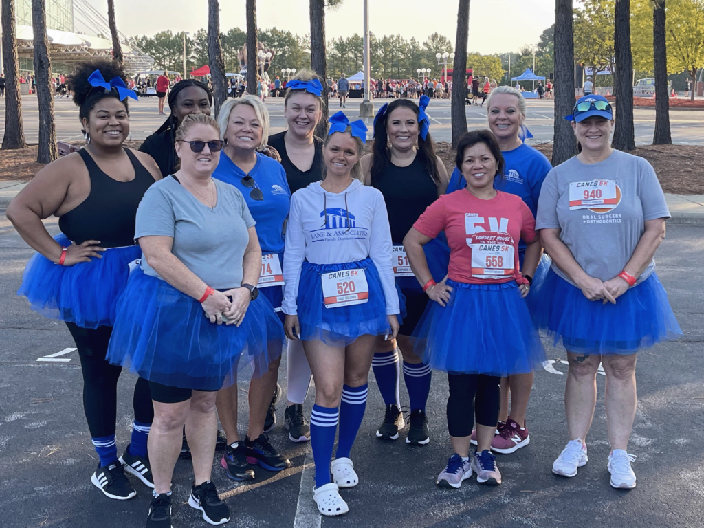 Lane Employees smiling in blue tutus 